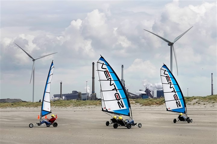 Beach sailing, with wind turbines and Tata Steel plant in the background