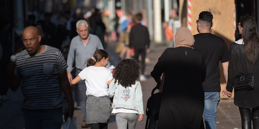 People walking down a shopping street.