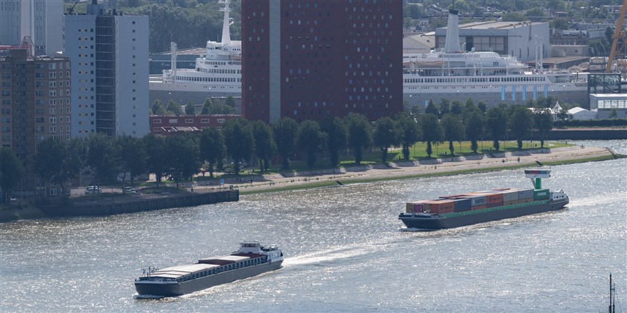 Inland vessel sailing through Rotterdam