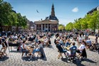 Cafés and restaurants with outdoor seating on a sunny day at Vismarkt in Groningen city