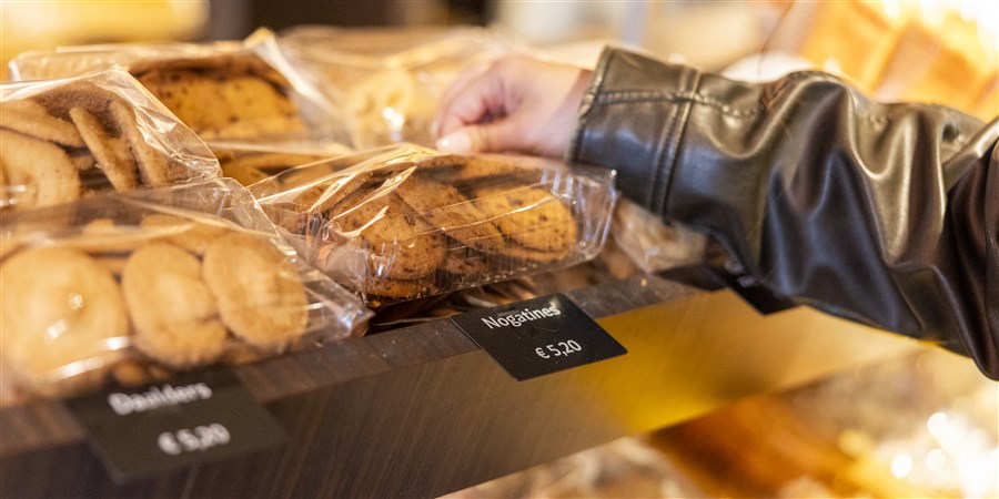 Hand pakt koekjes uit een schap
