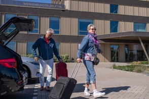 Middle-aged couple outside a hotel