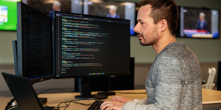 Researcher working with data behind his computers