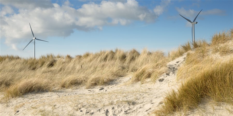 Windmills behind sanddunes