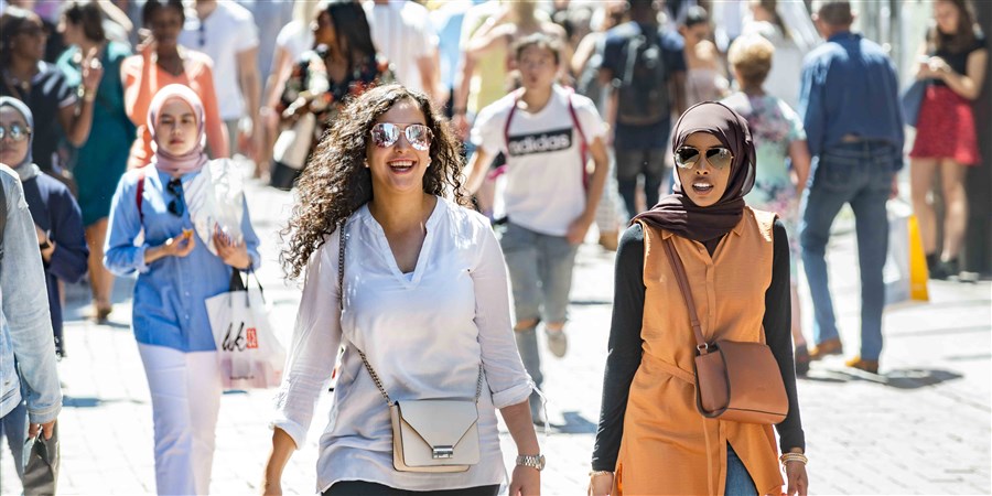 Winkelende mensen lopen door een winkelstraat