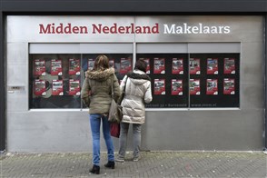 The Heerlen office of Statistics Netherlands, with a sign in the foreground displaying its logo and the full Dutch name in text: Centraal Bureau voor de Statistiek.