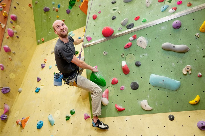 Cas climbing a wall