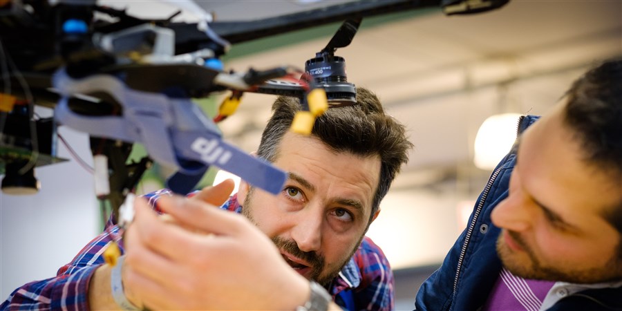 Two men are looking at a drone during the Eindhoven drone fe