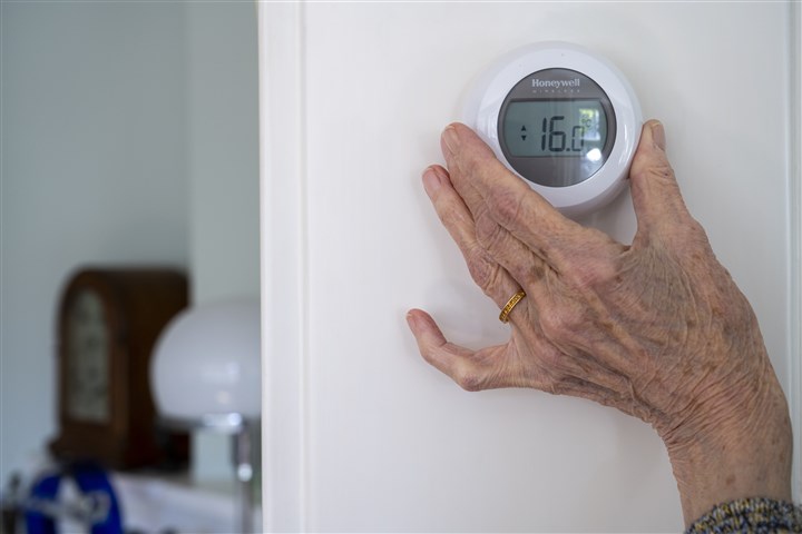 Woman turns down heating
