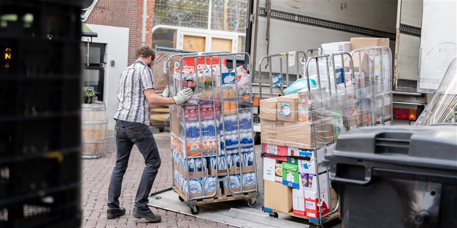 A man unloads food from a lorry