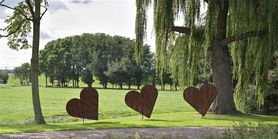 Three hearts made of copper at a cemetary