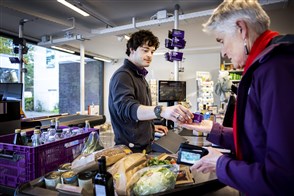 The Heerlen office of Statistics Netherlands, with a sign in the foreground displaying its logo and the full Dutch name in text: Centraal Bureau voor de Statistiek.