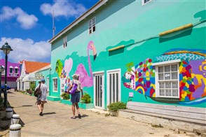 Tourists explore the colourful streets of Kralendijk, capital of Bonaire, Caribbean Netherlands.
